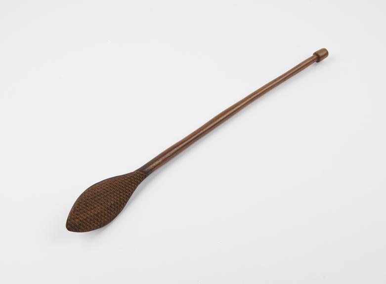 Wooden back scratcher with cylindrical stem terminating in a