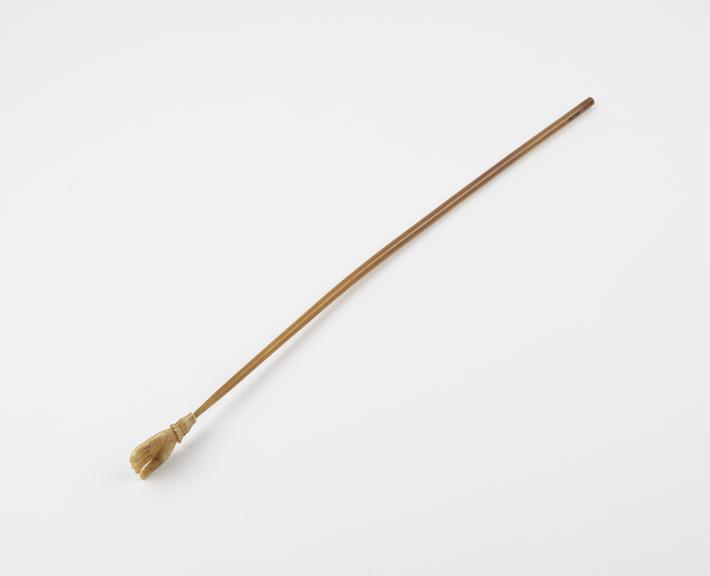 Horn-handled, ivory back scratcher, in form of hand, English