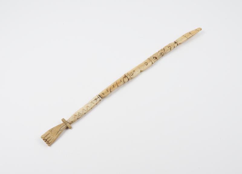 Long ivory back scratcher in the form of a hand, English