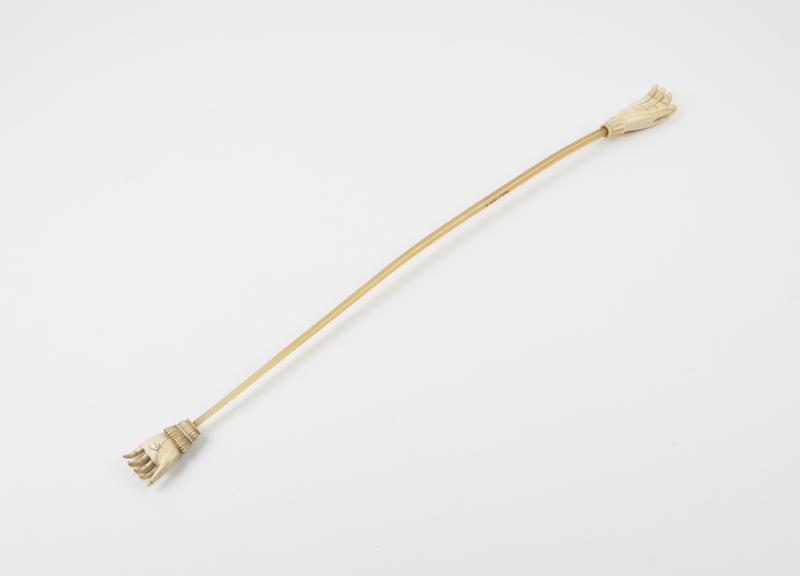 Whalebone rod, cylindrical, with ivory hand at each end