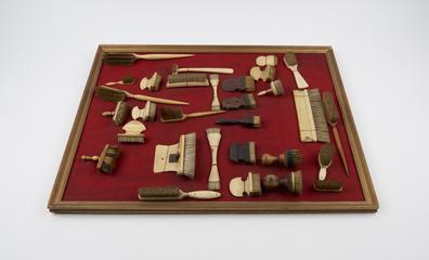 Brush with curving crescent shaped handle of bone