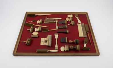 Brush with curving crescent shaped handle of bone