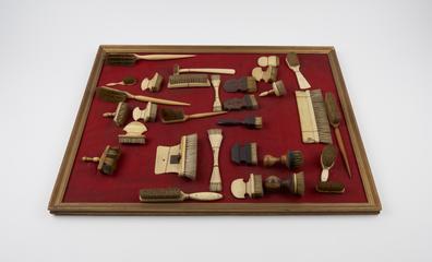 Brush with curving crescent shaped handle of bone