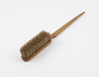 Wooden brush with short head and long handle tapering to point