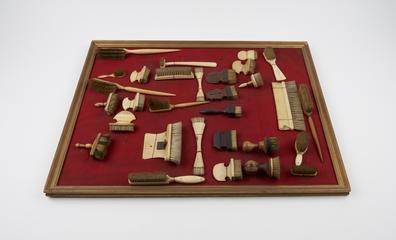 Flat bone handled brush with comb sliding into back