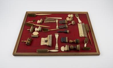 Wooden brush with short head and long handle tapering to point