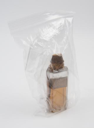 Bottle of light brown liquid