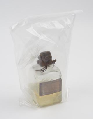 Bottle of pale yellow liquid