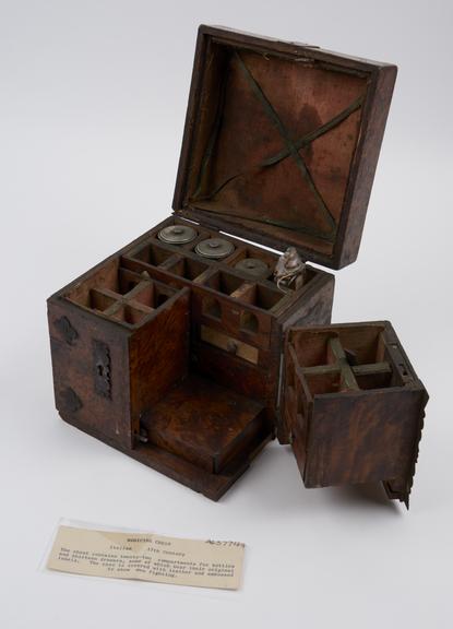 Ironbound walnut medicine chest with loop handle on lid,