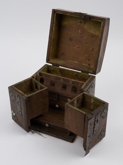 Iron-bound medicine chest of wood in 3 hinged sections with lid