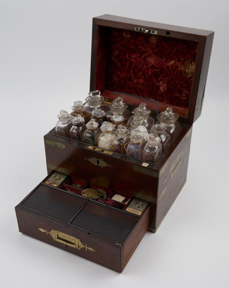 Walnut medicine chest with 22 glass bottles, unlabelled