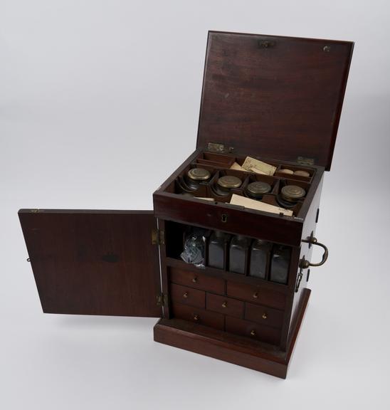 Mahogany medicine chest containing 8 glass bottles