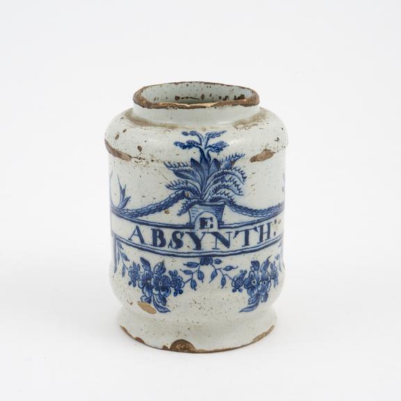 Tin-glazed earthenware drug jar, signed, flowering aloes design