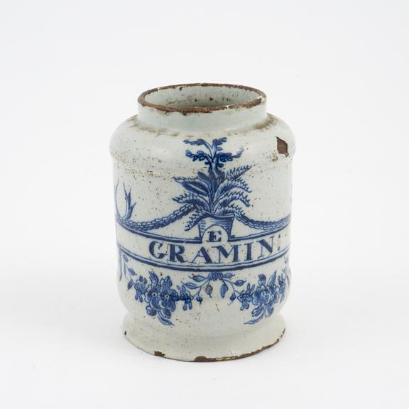 Tin-glazed earthenware drug jar, signed, flowering aloes design