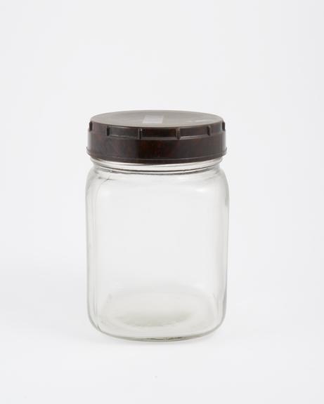 An empty glass jar used to house pathology specimens at