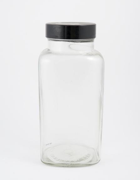 An empty glass jar used to house pathology specimens at