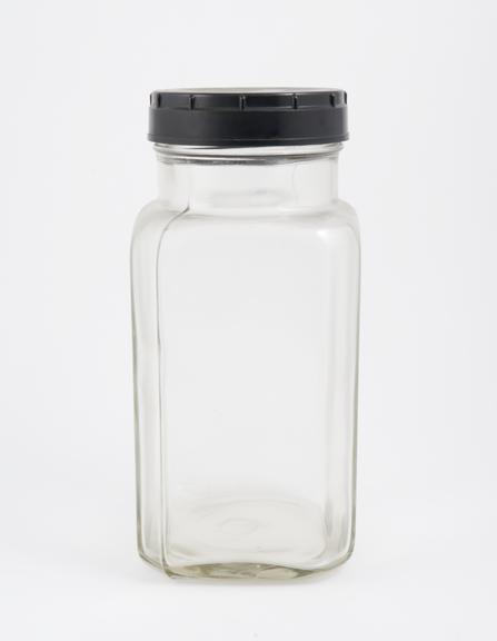 An empty glass jar used to house pathology specimens at