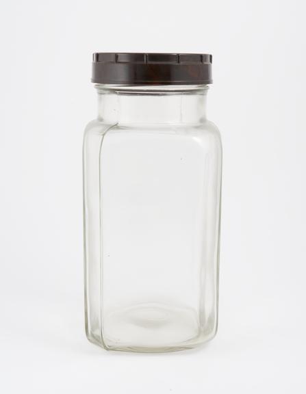 An empty glass jar used to house pathology specimens at