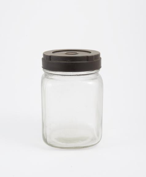 An empty glass jar used to house pathology specimens at