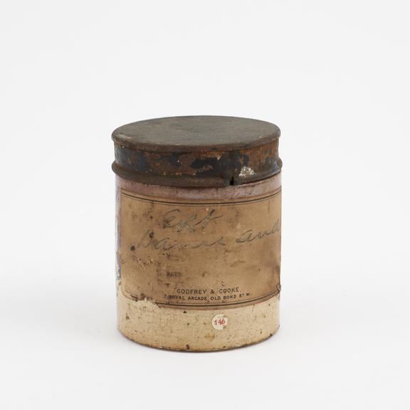 Small salt glazed stoneware dispensing pot containing damiana