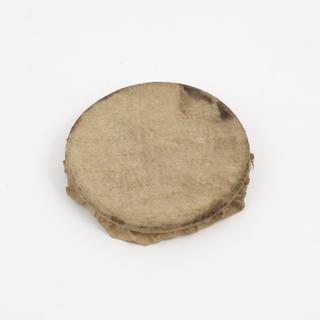 Rim of glass drug jar with parchment cover