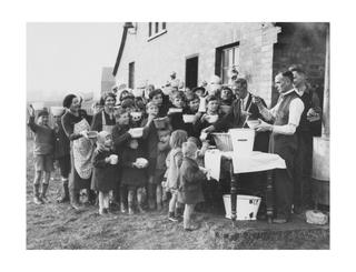 Photograph showing people receiving food from a soup kitchen