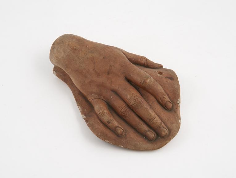 Terracotta cast of a right hand, female, Alcora wax, Italian