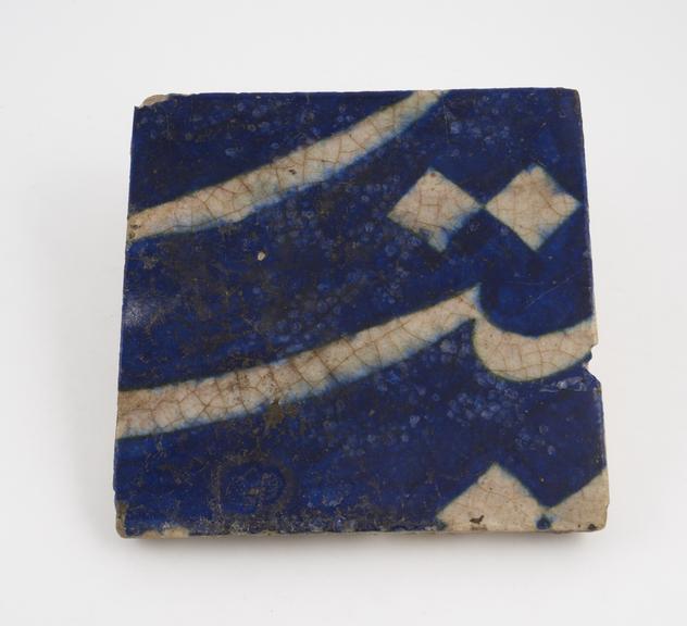 Tin glazed earthenware mosque wall tile with fragment of