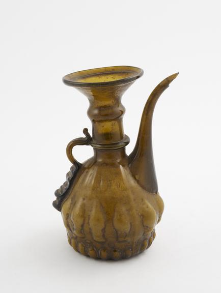 Glass jug, brown, with spout and handle, moulded body, Islamic