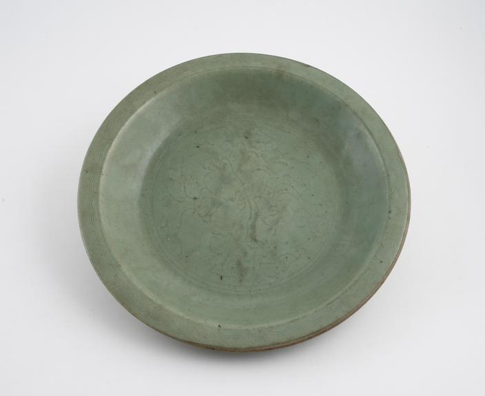 Green earthenware dish, with foliate design in darker green