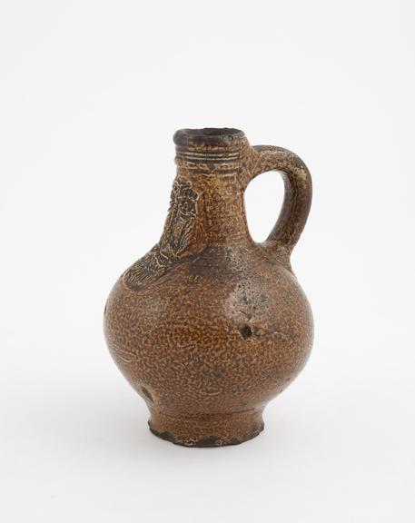 Stoneware jug or Bellarmine', oval body with vertical handle