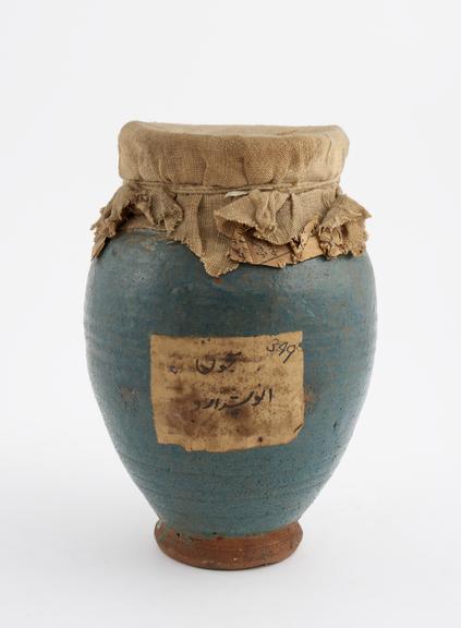 Blue glazed earthenware jar containing some unidentified