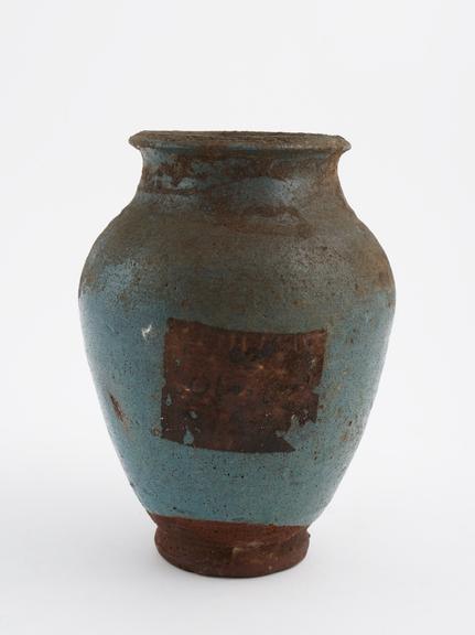 Blue glazed earthenware storage jar containing resin and fruit