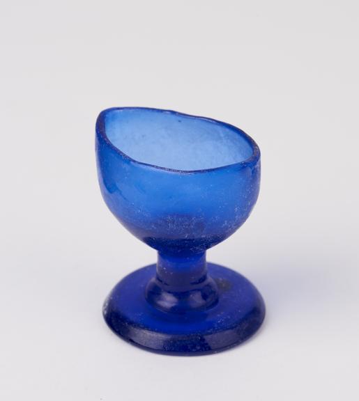 Glass eye bath, blue with stem, blown, European, 1851-1920