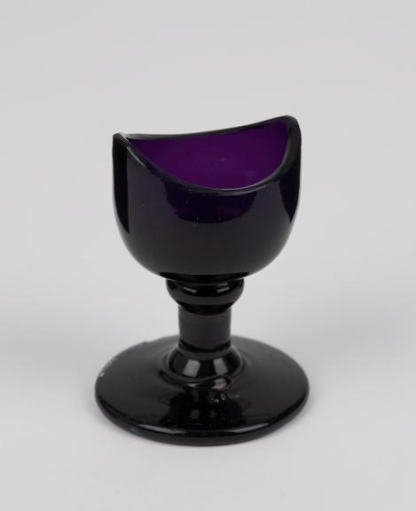 Glass eye bath, purple, with stem, blown, European, 1801-1900