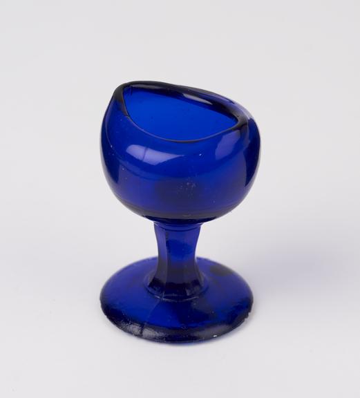 Blue glass eye-bath moulded and with stem, probably English