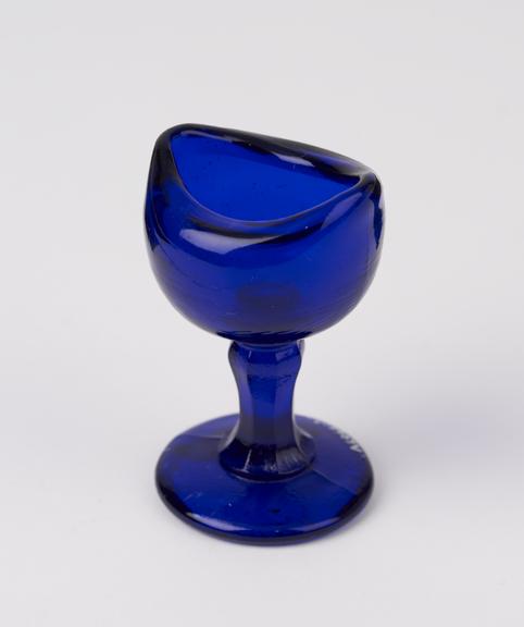 Blue glass eye-bath with stem, English, 20th century