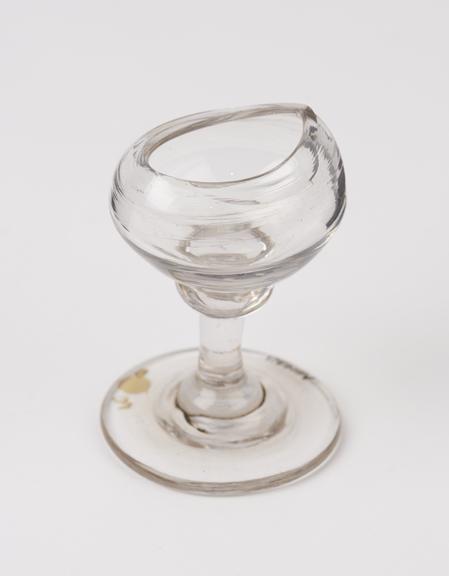 Clear glass eye bath, blown and with stem, probably 19th century