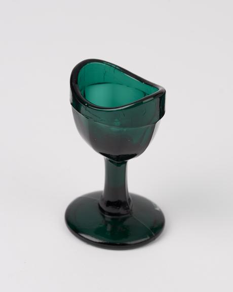 Glass eye bath, green, with stem, moulded, European