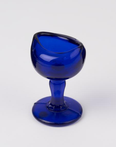 Blue glass eye bath moulded and with stem, probably English,