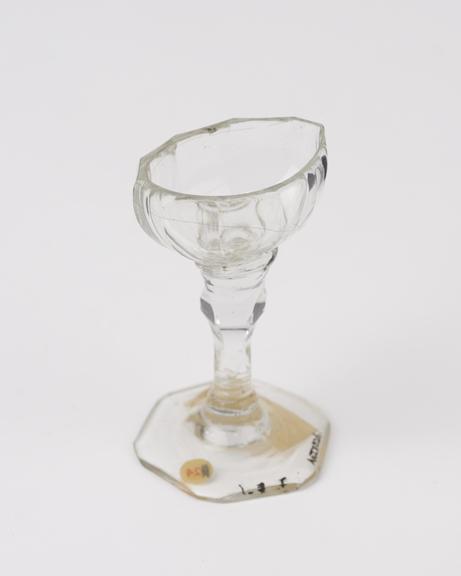 Glass eye bath, colourless, with stem, European, 19th century