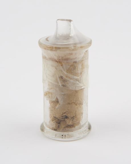 Glass specimen jar containing an unidentified solid