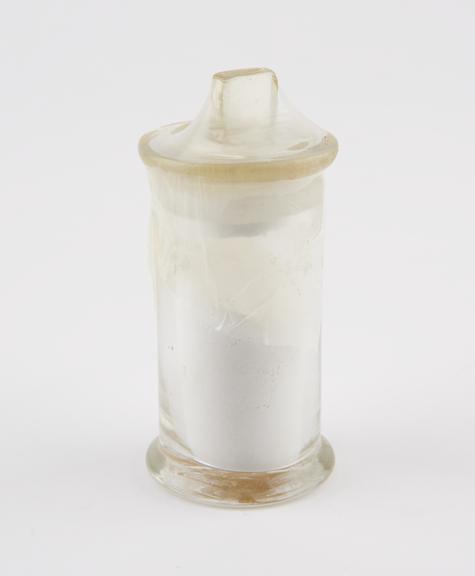 Glass specimen jar, half full of zinc cyanide powder