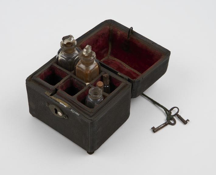 Medicine chest, fishskin covered, with five empty glass bottles