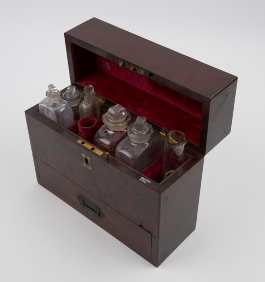 Narrow rectangular mahogany medicine chest with 5 glass bottles