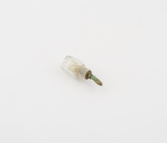 Small glass bottle containing a wick