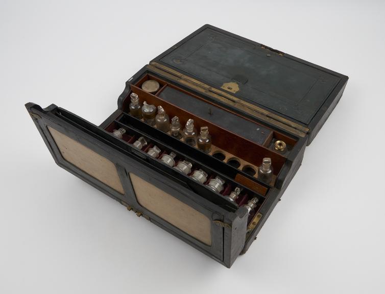 Medicine chest, wood and leatherette, with 44 glass bottles