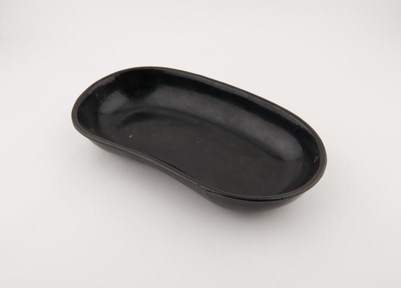 Kidney-shaped dressing bowl made from gutta-percha. Made in England