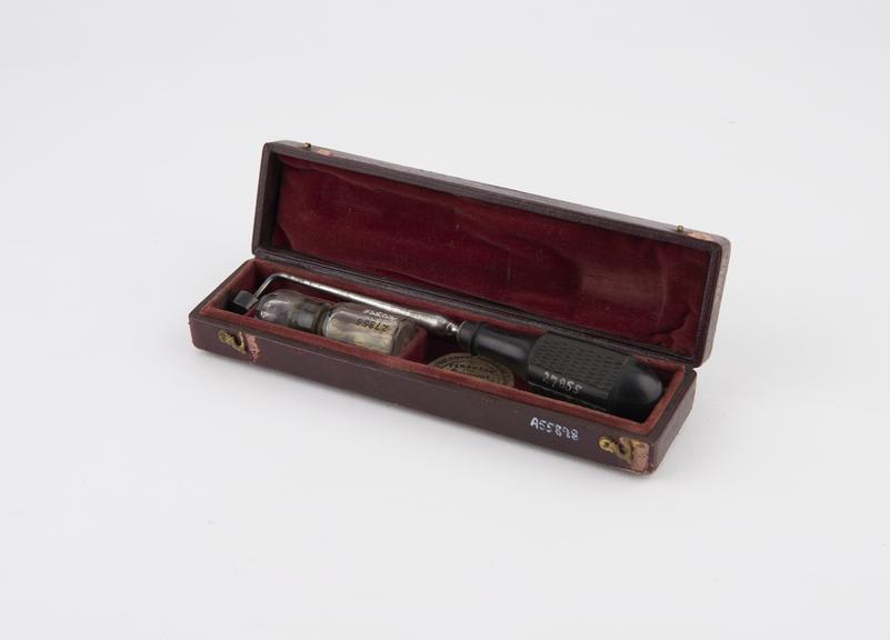 Cautery set comprising iron and lamp in case, Corrigan's button