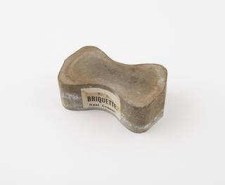 Briquette of neat cement for testing